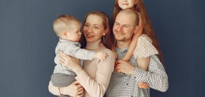 A joyful family portrait showcasing parents and their two children, expressing love and togetherness.