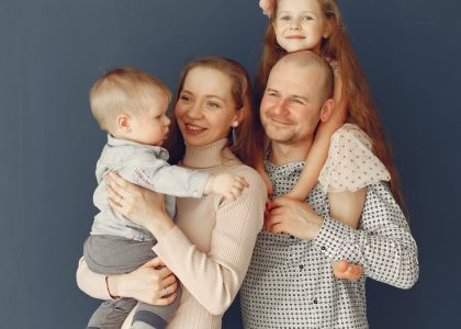 A joyful family portrait showcasing parents and their two children, expressing love and togetherness.